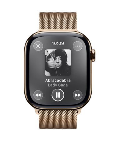 Apple Watch in Gold Titanium with Milanese loop band, face shows Apple Music playing, translucent Liquid Glass controls