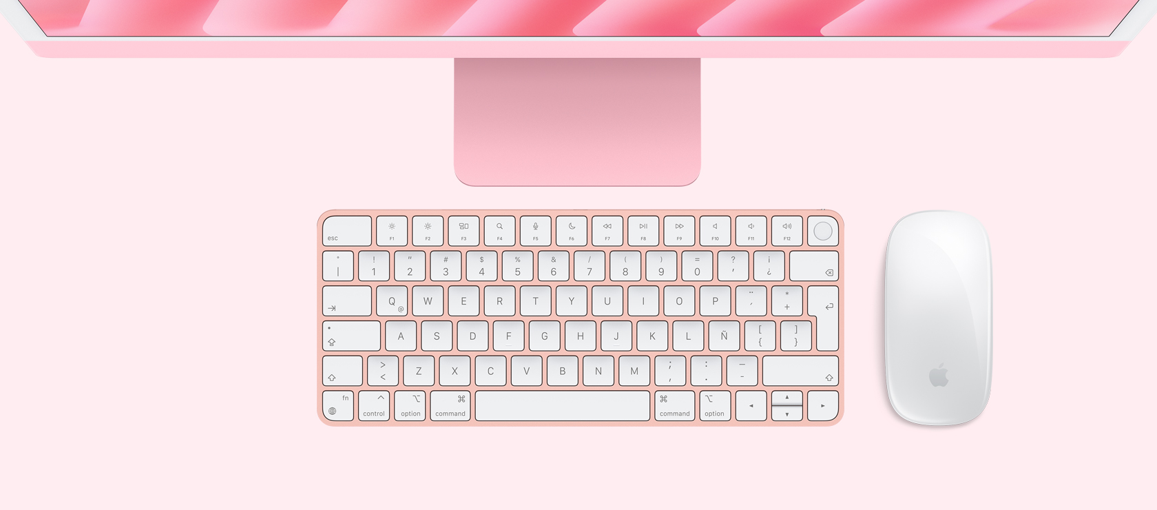 Vista panorámica de un iMac rosado con mouse y teclado a juego