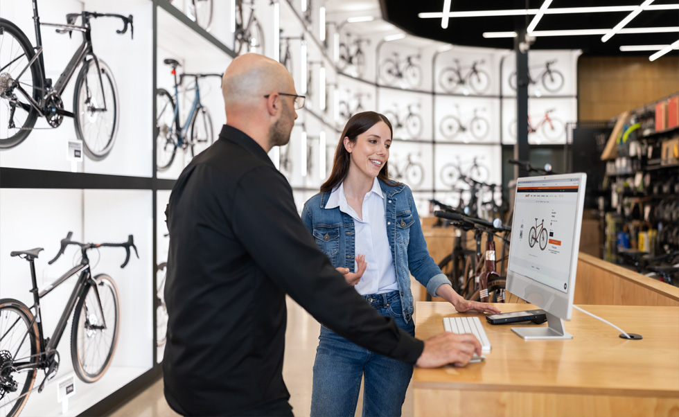 Julien Sicuro, Store Manager, walks a customer through bicycle selection using the crystal-clear Retina display on iMac.